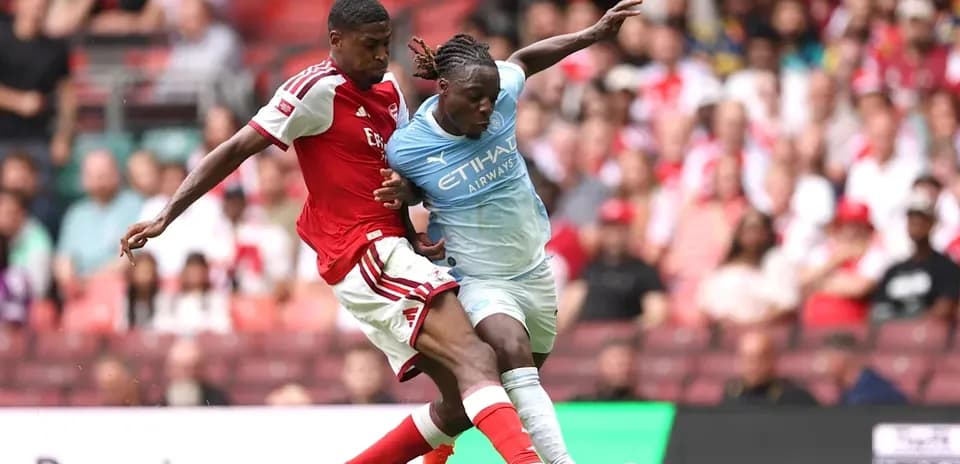 Two players contesting for the ball during match
