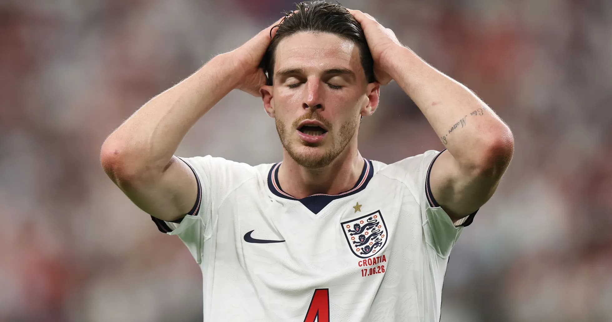 Player in England jersey with hands on head