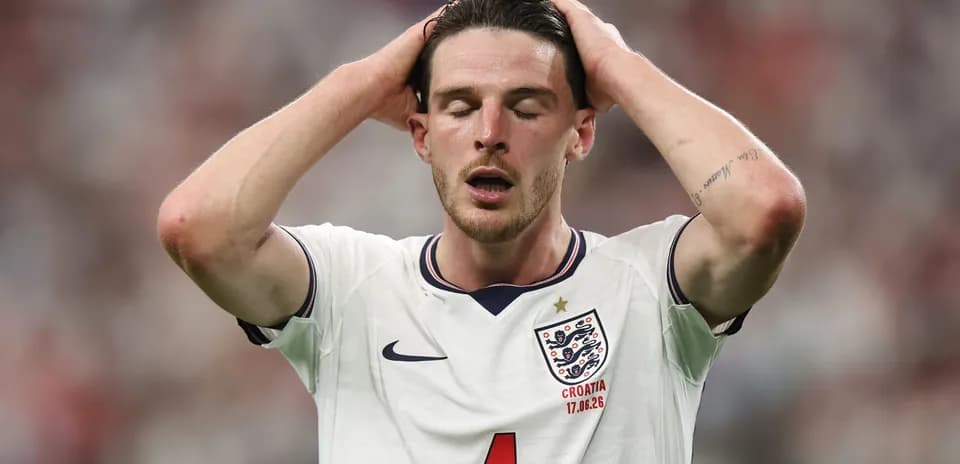 Player in England jersey with hands on head