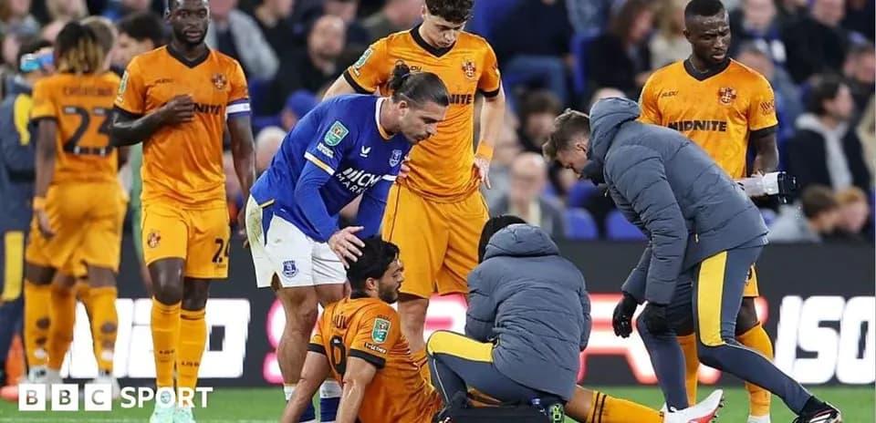 Player receiving medical attention during football match