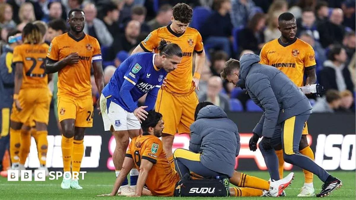 Player receiving medical attention during football match