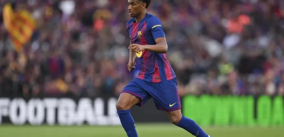 Barcelona player dribbling the ball on field