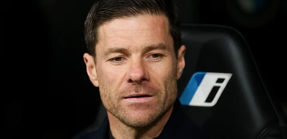 Manager seated on bench during match