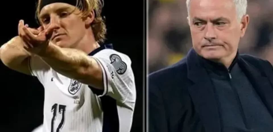 Football player celebrating goal alongside manager