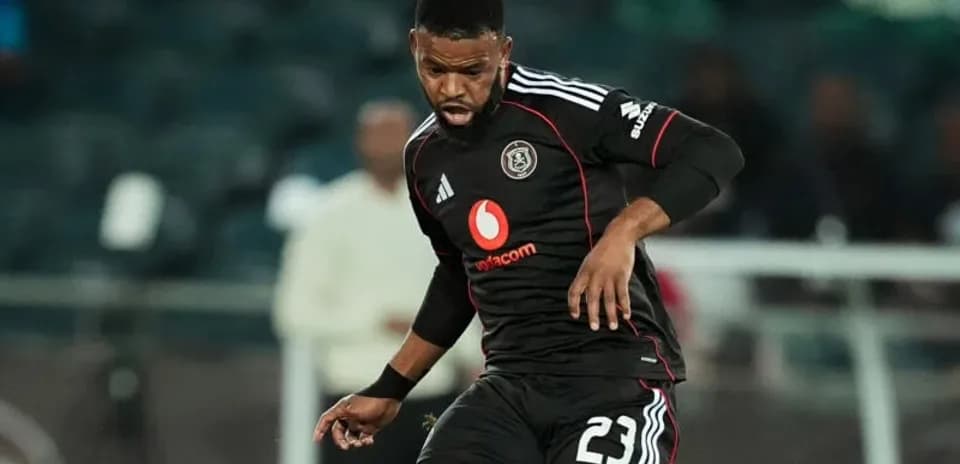 Player in black kit controlling ball during match
