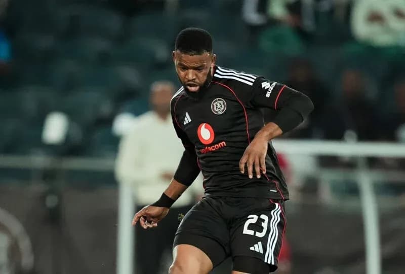 Player in black kit controlling ball during match