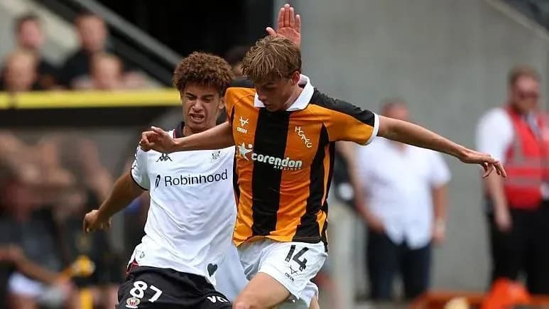 Two players battling for the ball during match