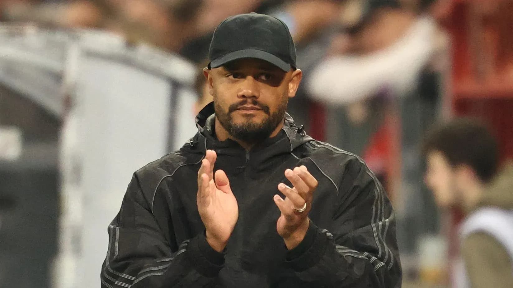 Coach applauding during match from the sidelines