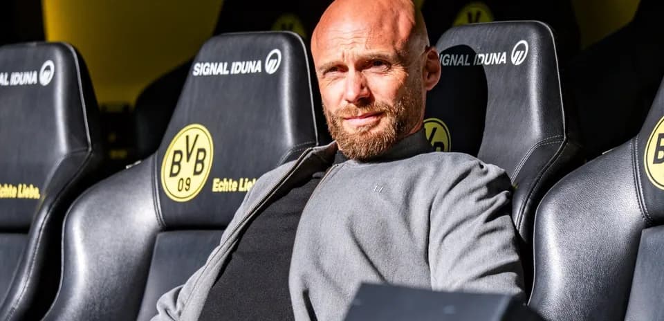 BVB coach seated on the bench during match