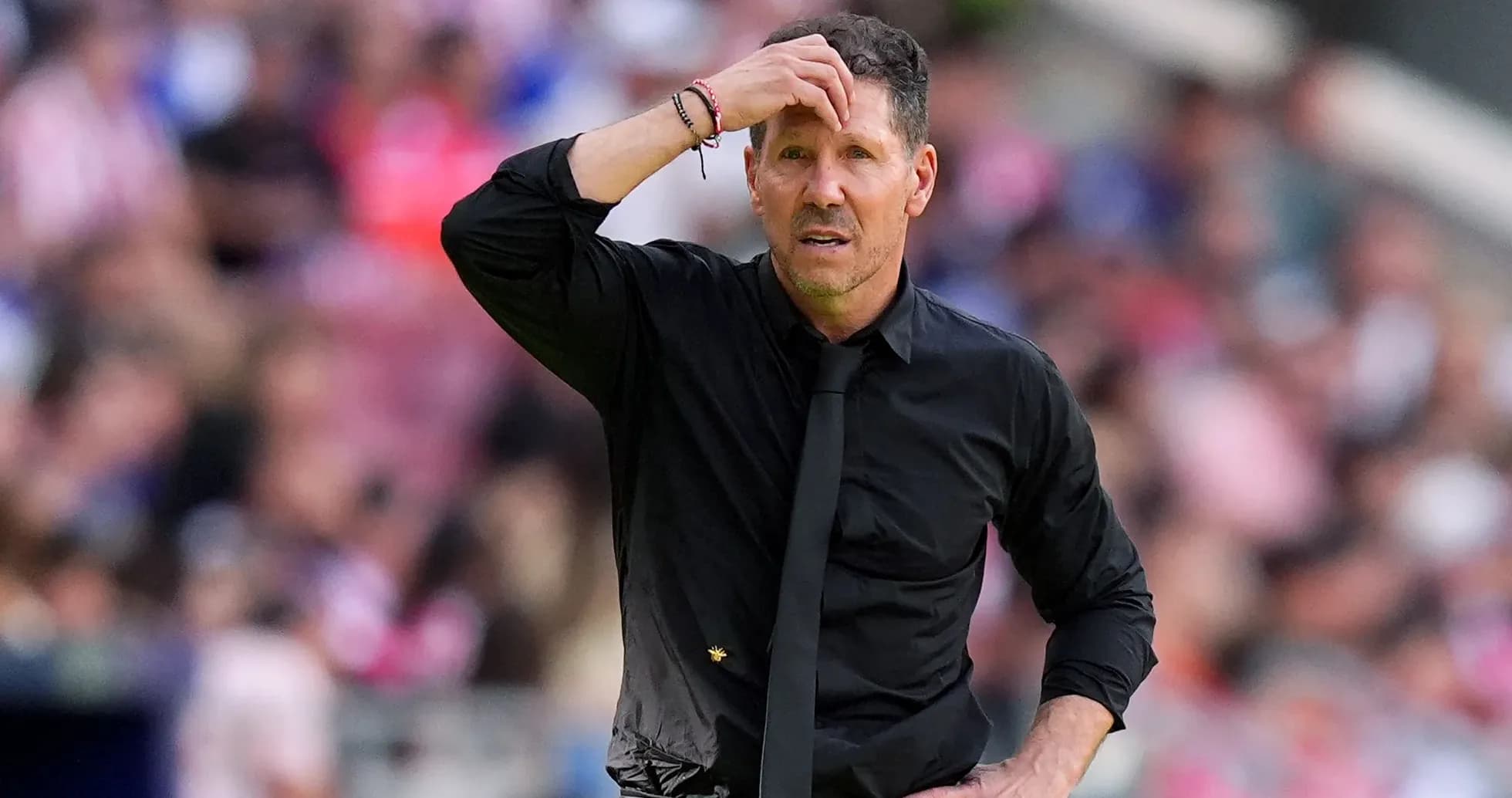 Football manager looking concerned during match