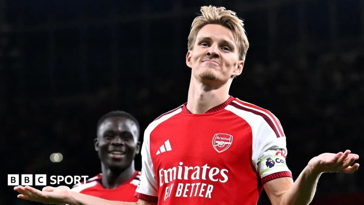 Arsenal player celebrating with teammate after goal