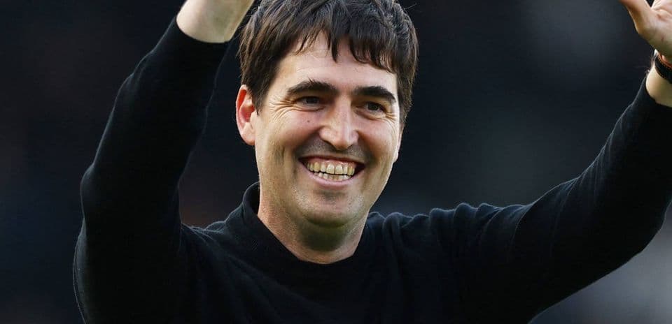 Coach celebrating with raised hand and smile