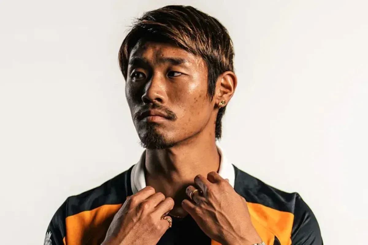 Athlete posing in team jersey with accessories