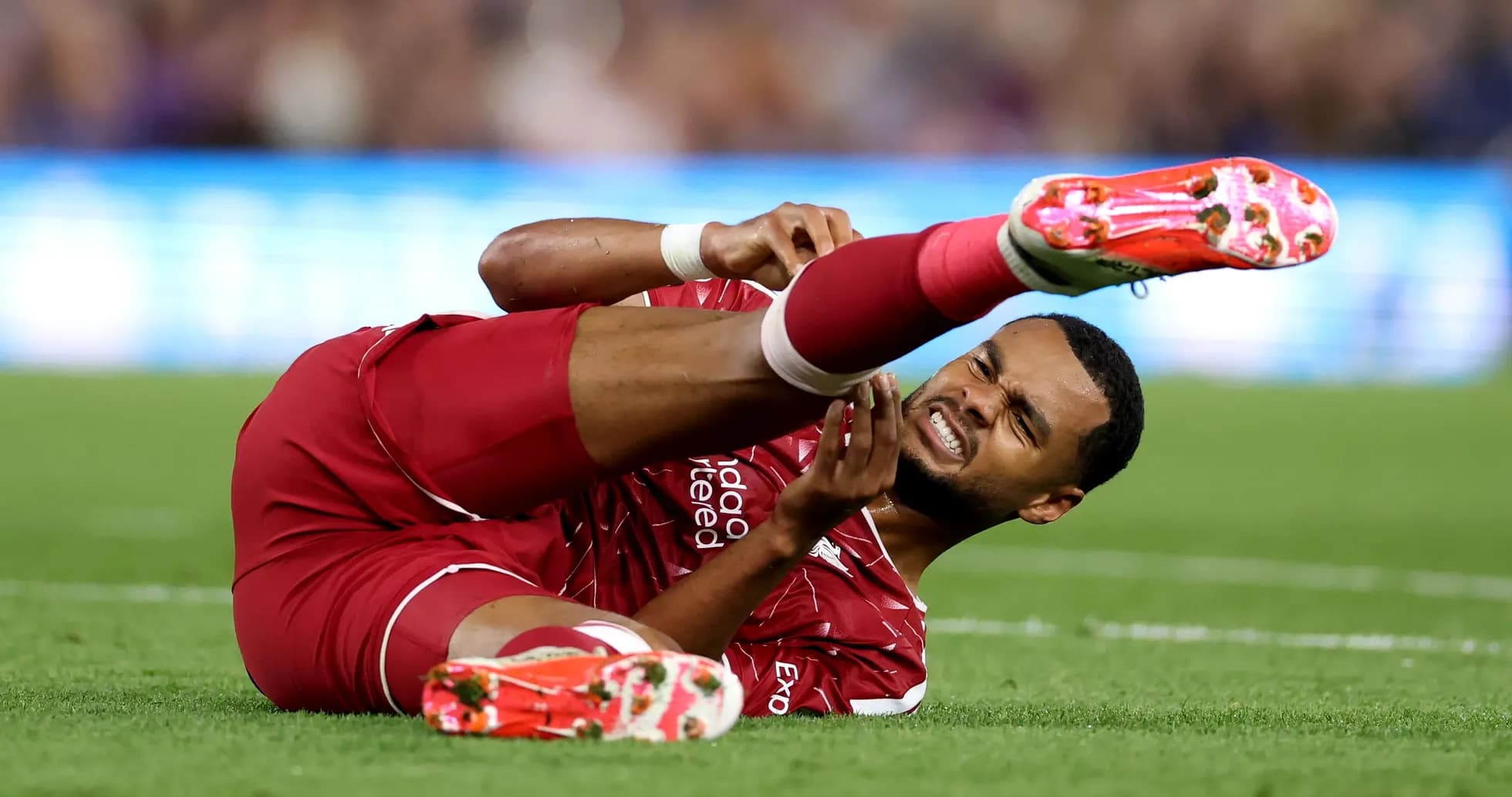 Player on ground holding injured leg during match