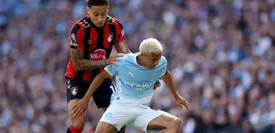 Bournemouth player challenging Manchester City opponent