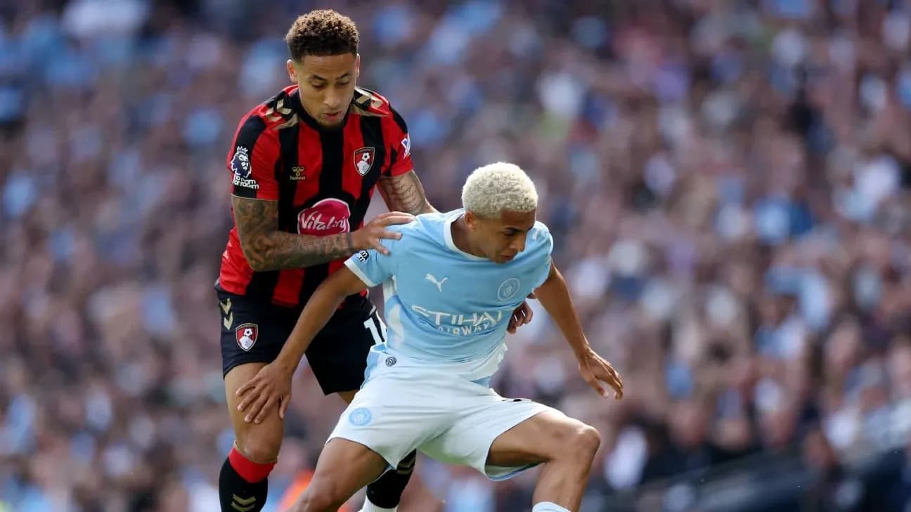 Bournemouth player challenging Manchester City opponent