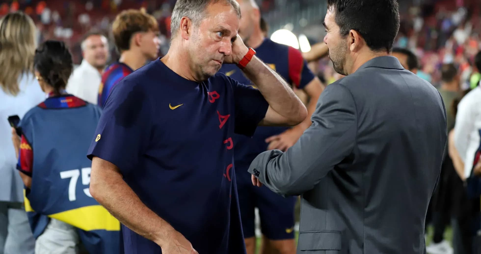 Coaches discussing after match in stadium