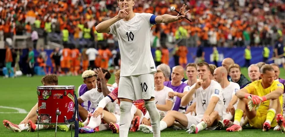 Player gesturing to silence while teammates sit behind