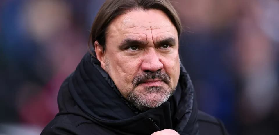 Football manager observing match from sidelines