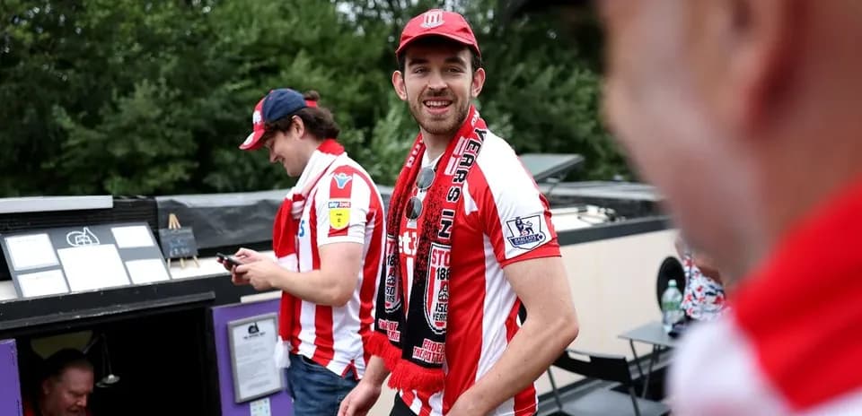 Stoke City fans wearing team jerseys and scarves