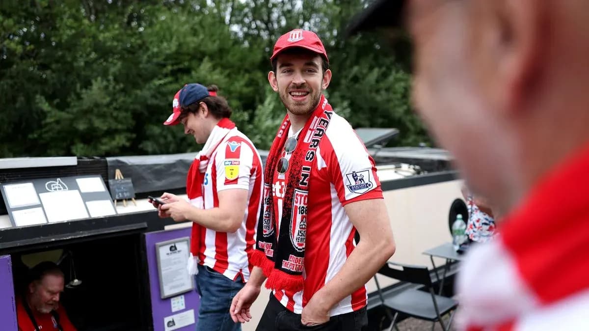 Stoke City fans wearing team jerseys and scarves