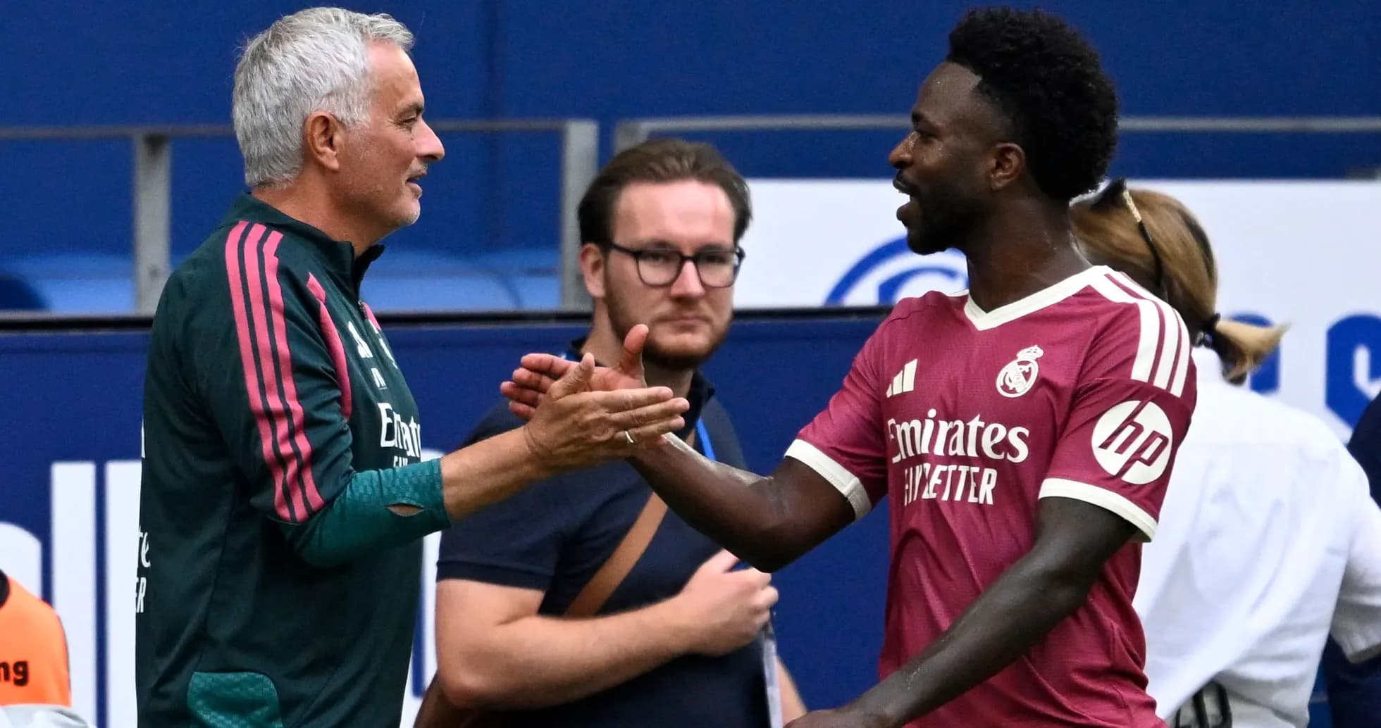 Jose Mourinho and player shaking hands on field