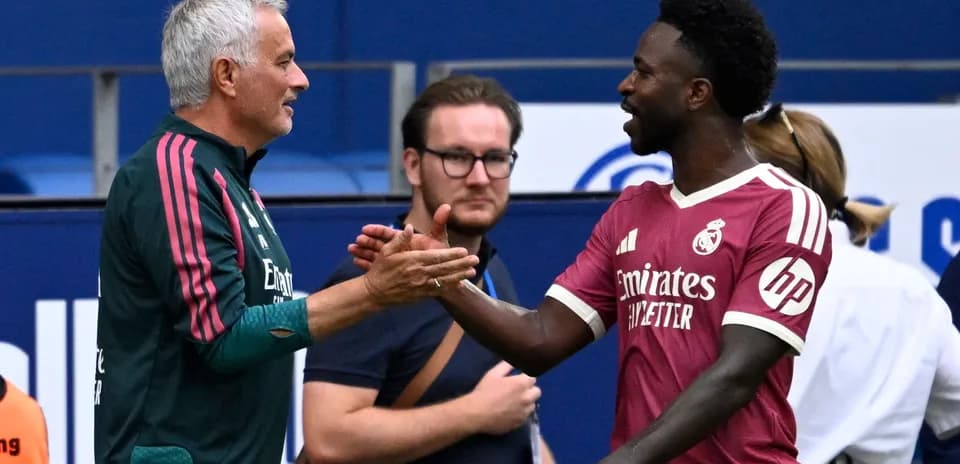 Jose Mourinho and player shaking hands on field