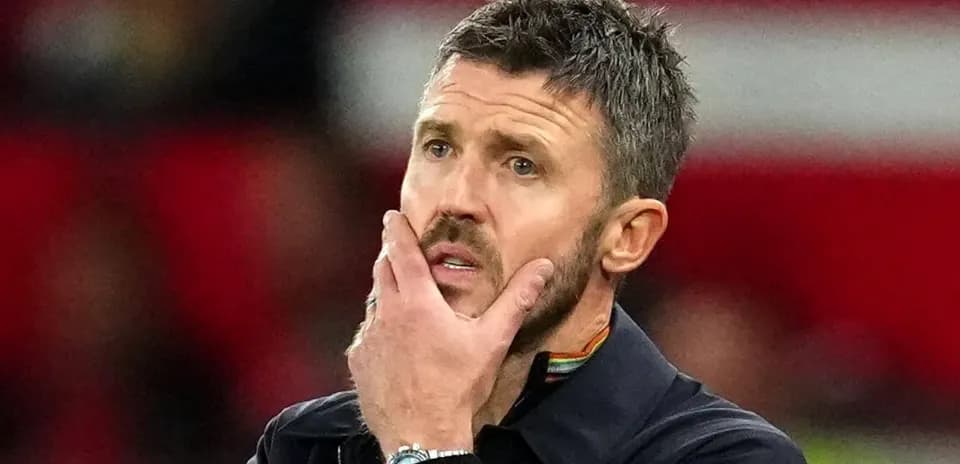Men's football coach in thought during match