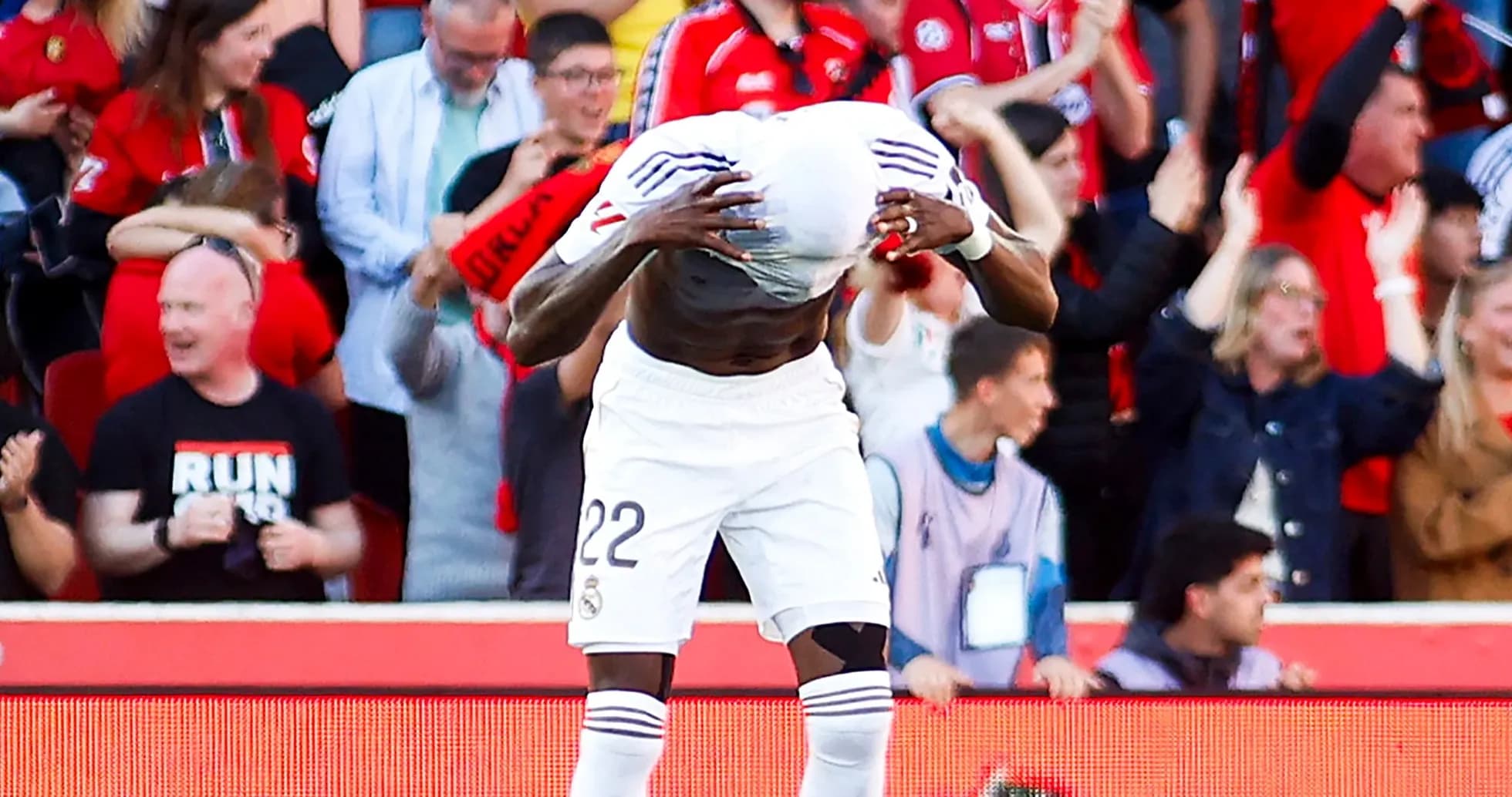 Player celebrating with fans after scoring goal