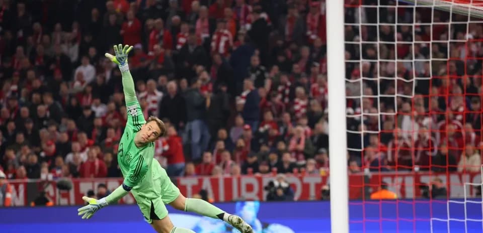 Goalkeeper diving to save a shot on goal