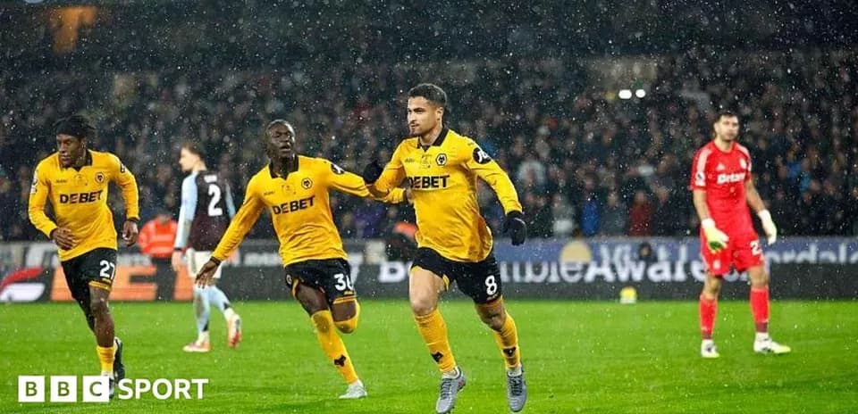 Wolverhampton players celebrating a goal in rain