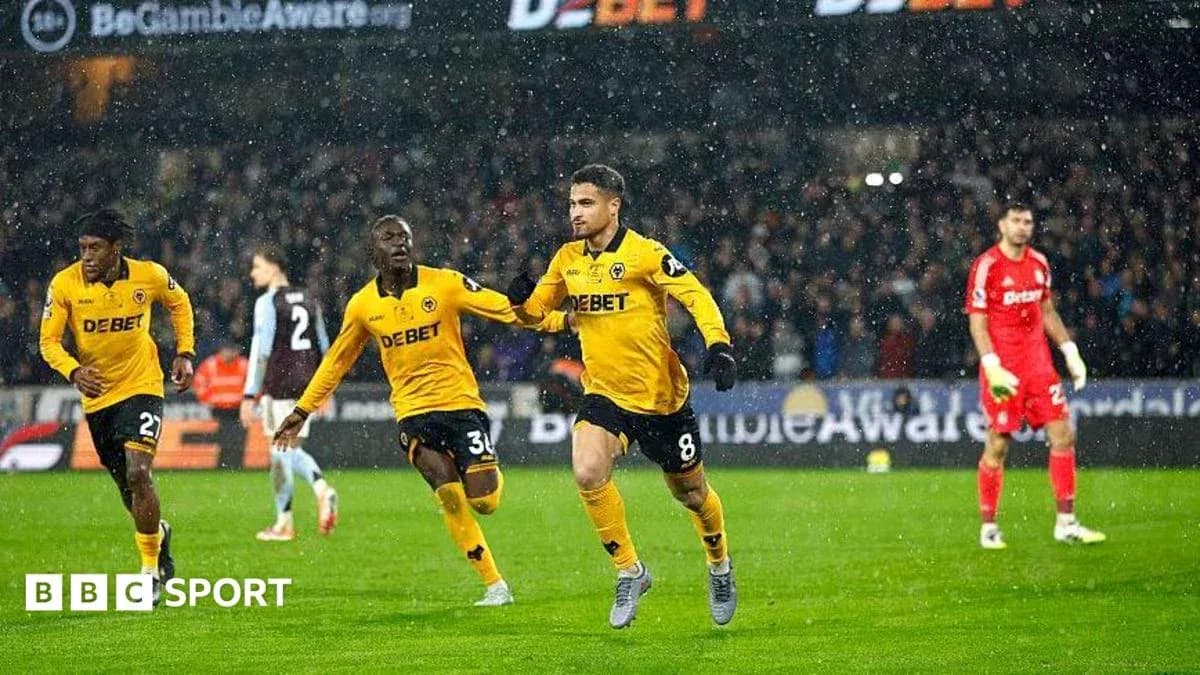 Wolverhampton players celebrating a goal in rain