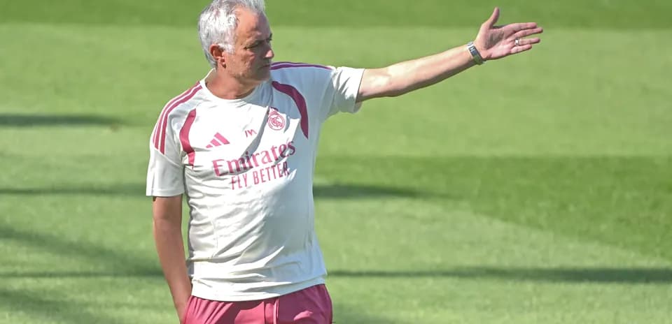 Men's football coach giving instructions during training