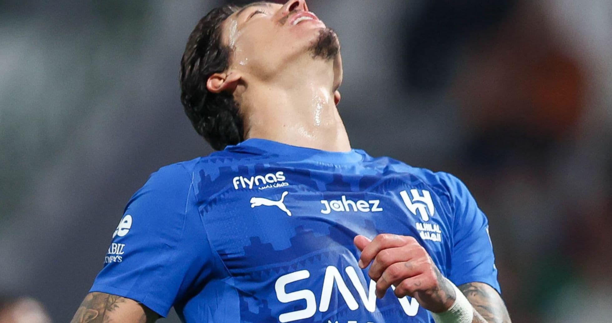 Player in blue jersey expressing frustration on the field
