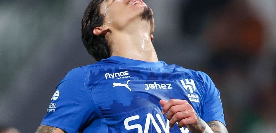 Player in blue jersey expressing frustration on the field