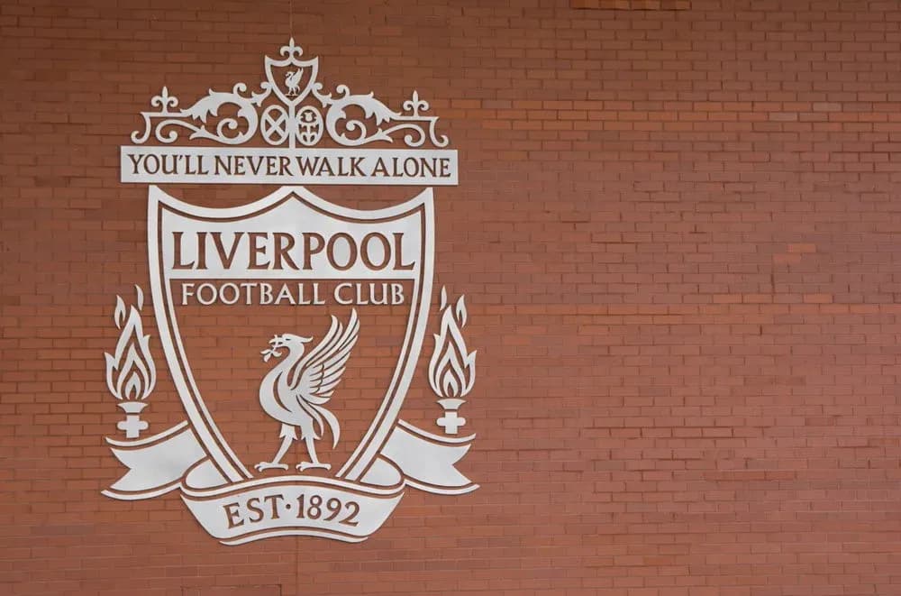 Liverpool FC crest on red brick wall