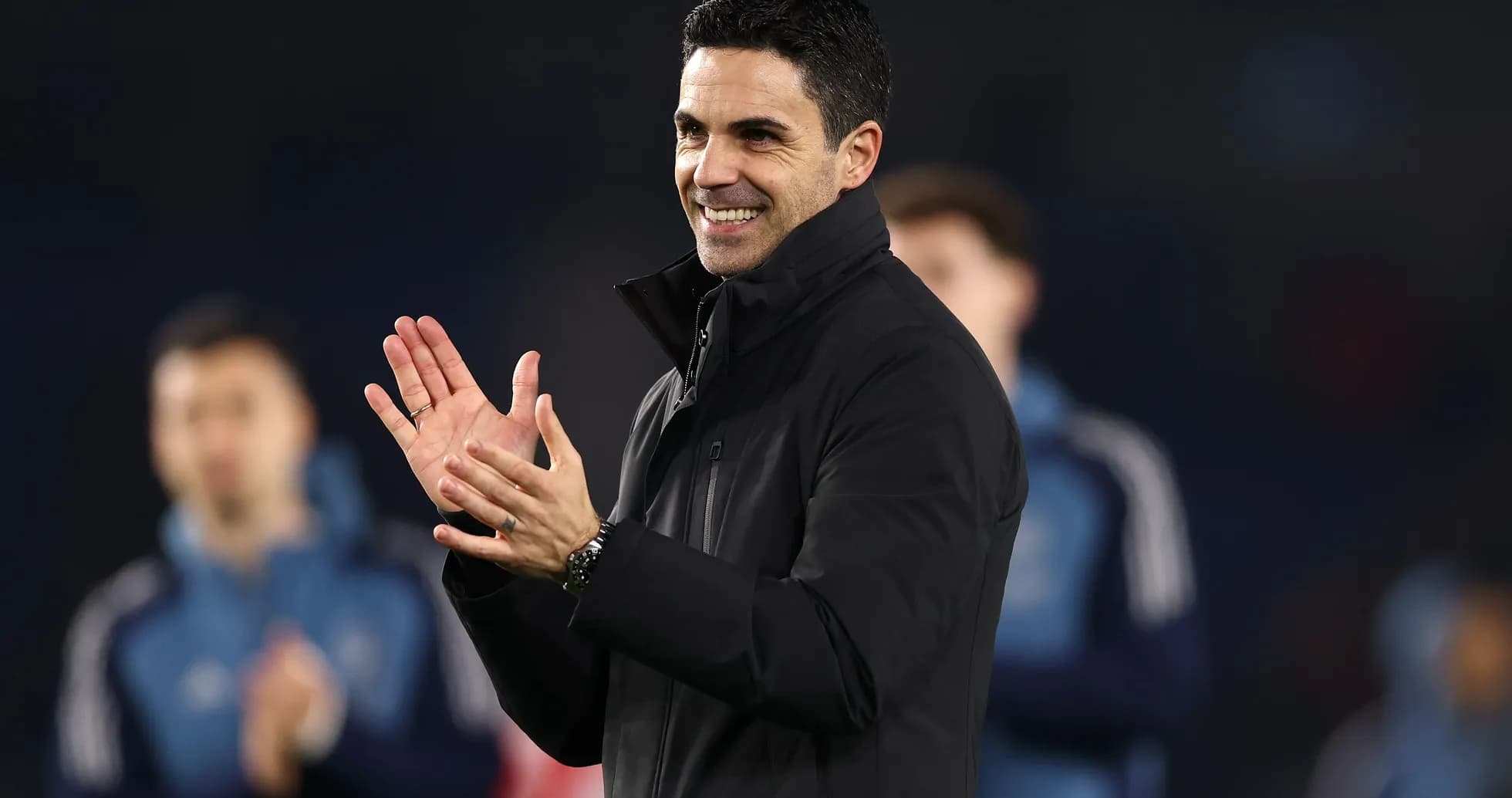 An individual clapping during a sporting event