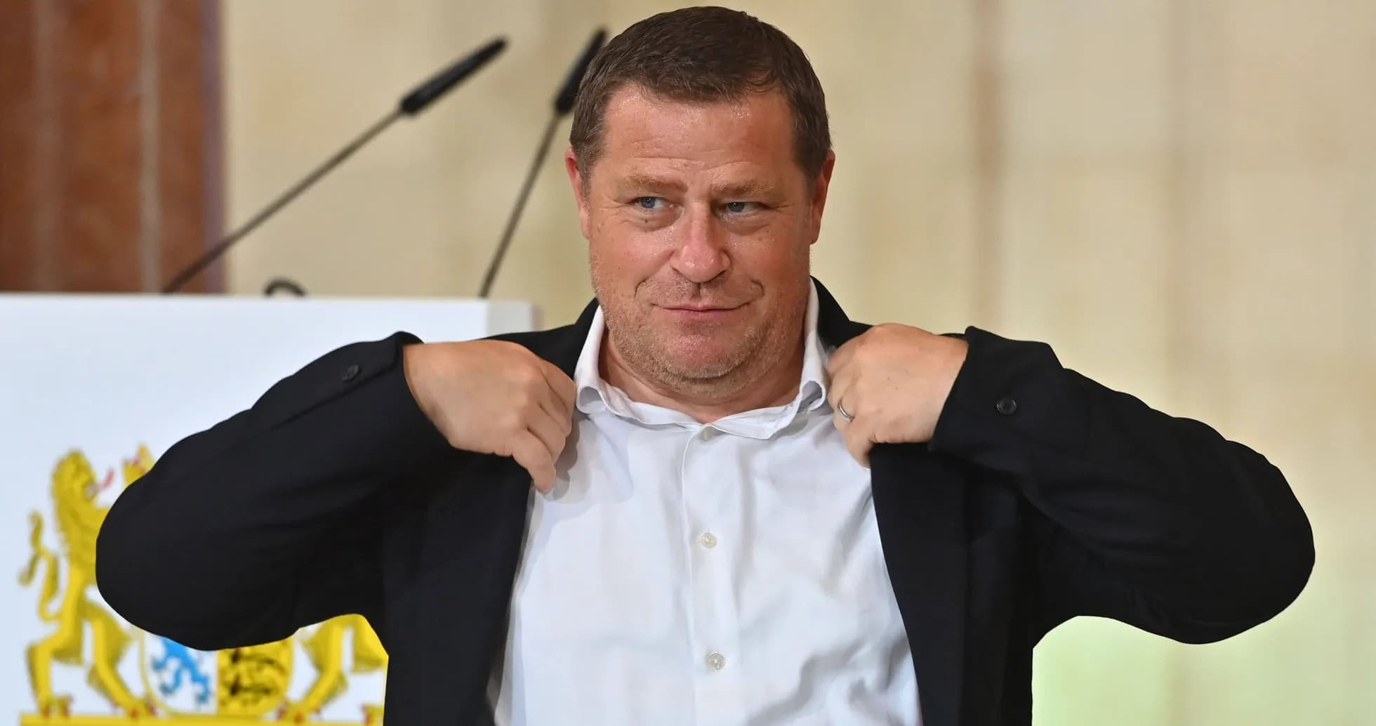 Person adjusting jacket at a podium