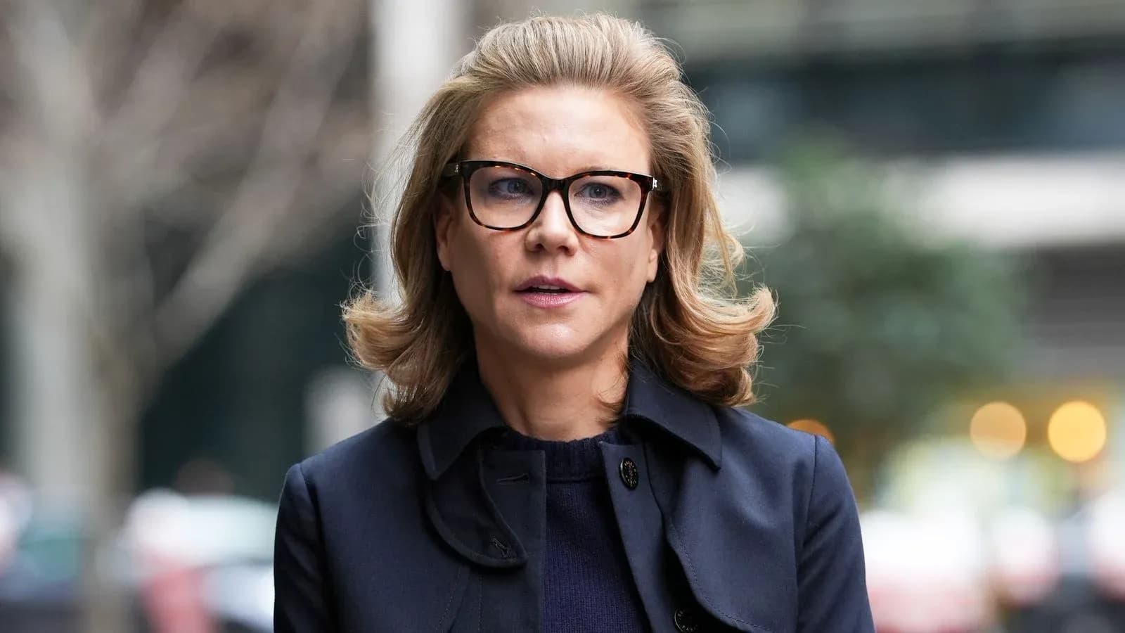 Woman with glasses outdoors in urban setting Woman with glasses outdoors in urban setting