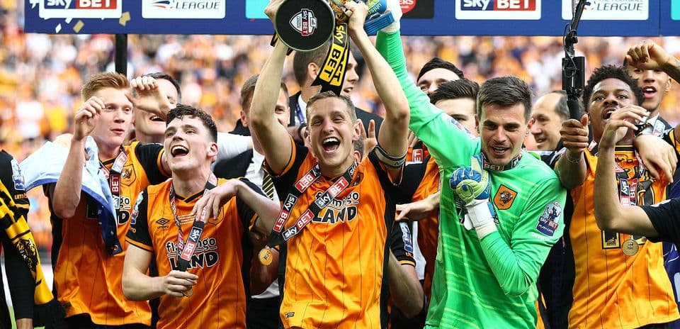 Hull City players celebrating with trophy after victory