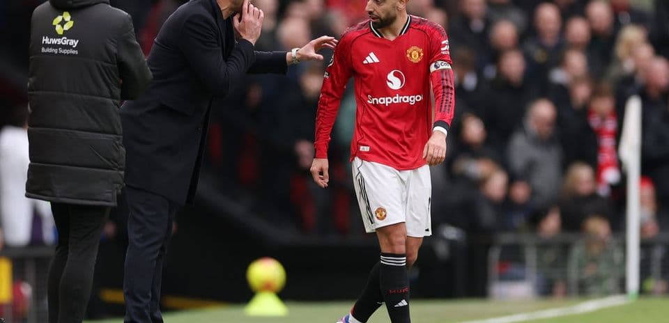 Bruno Fernandes receiving instructions from coach during match