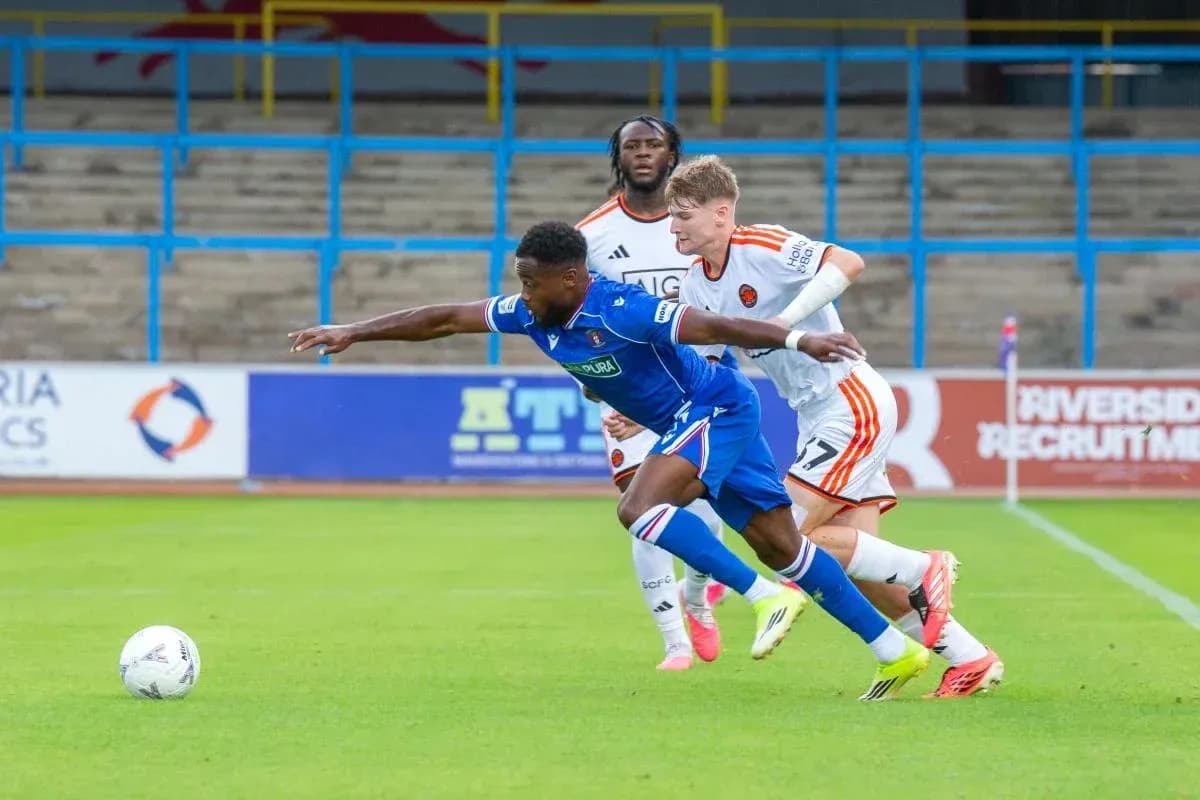 Player in blue jersey lunging for the ball