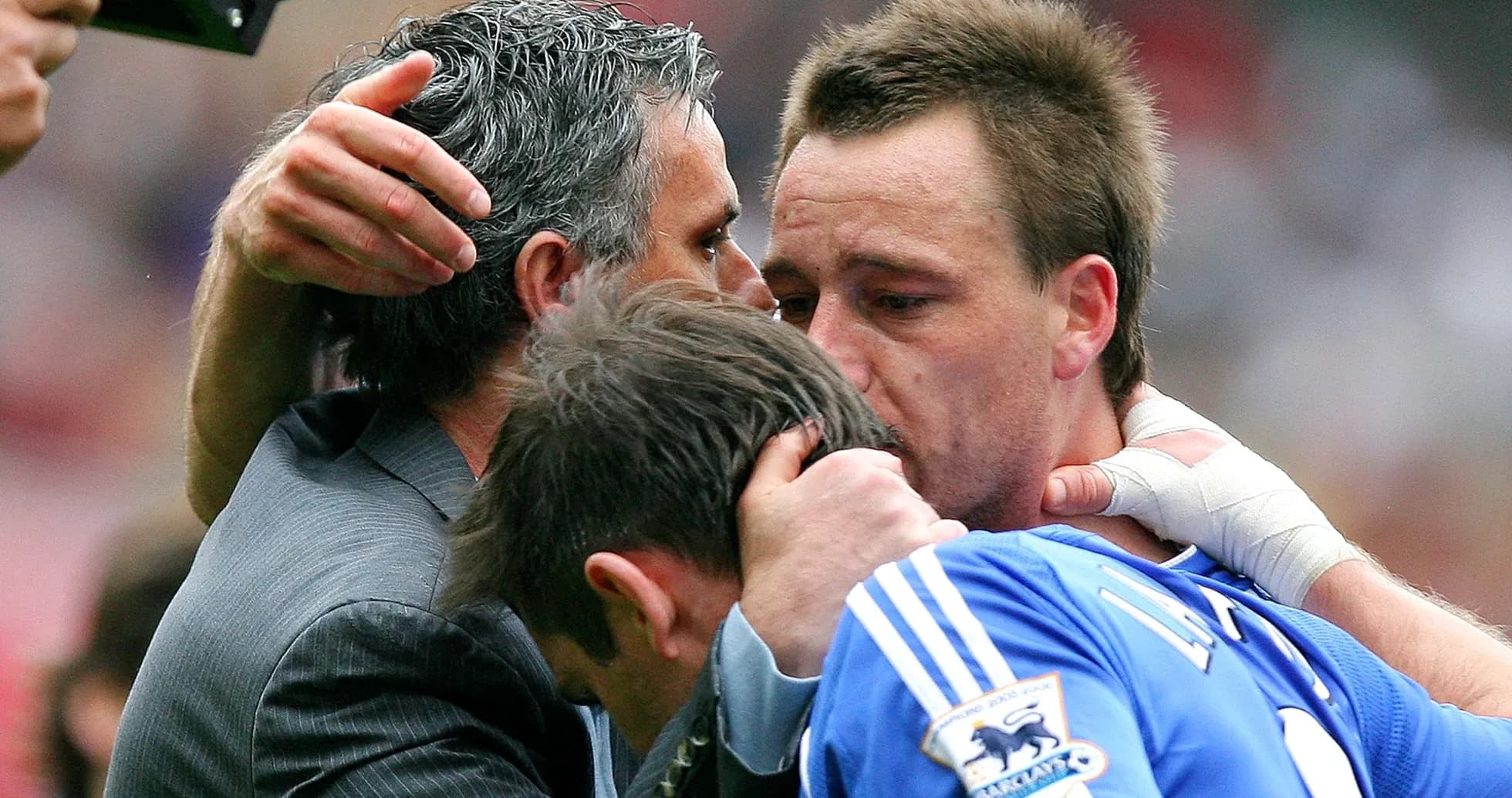 Three individuals embracing after a match