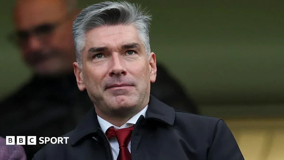 Man in suit observing from the stands at stadium