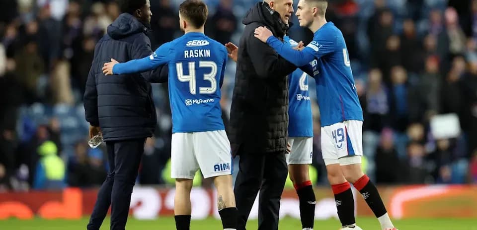 Rangers players and coach discussing on the pitch