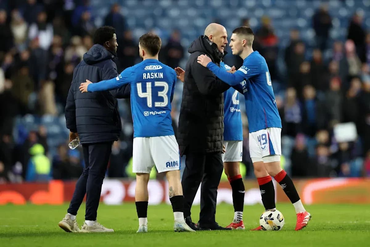 Rangers players and coach discussing on the pitch