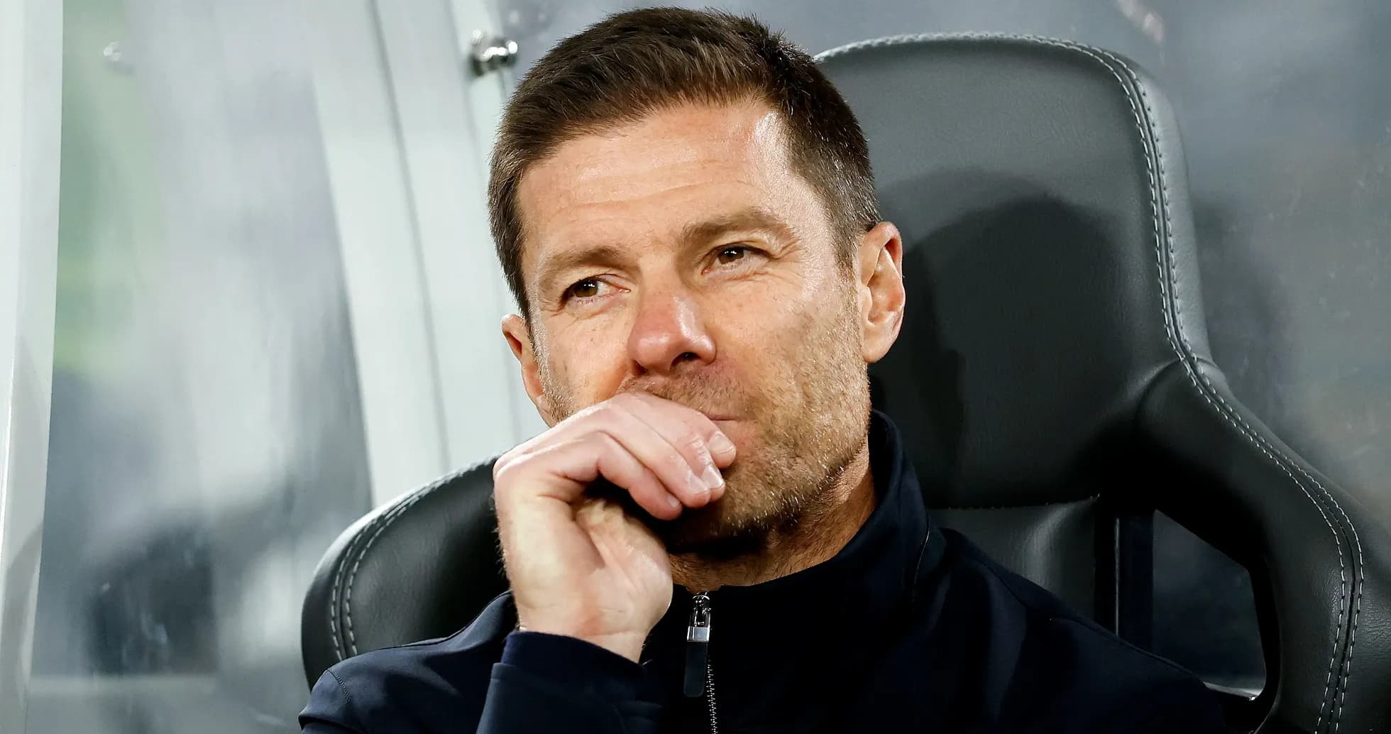 Coach sitting on bench during a match