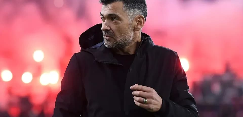 Coach on the sidelines during match with smoke background