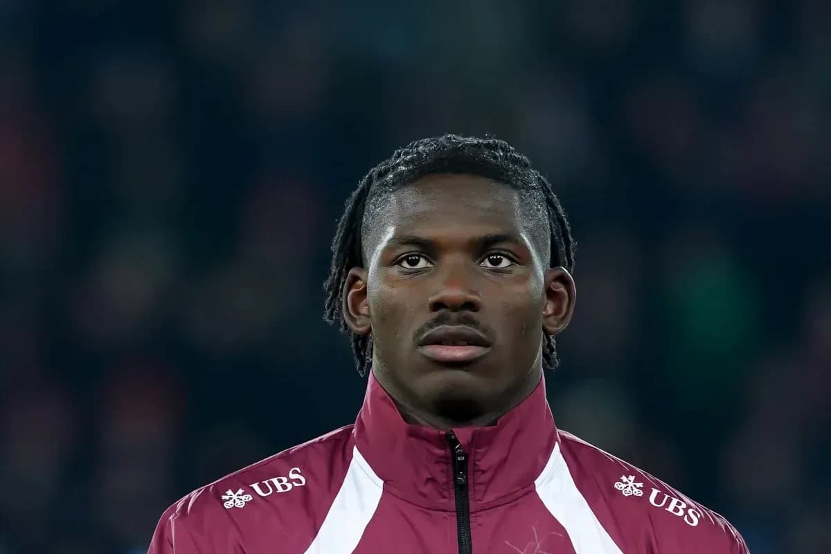 Player wearing maroon jacket during match preparation