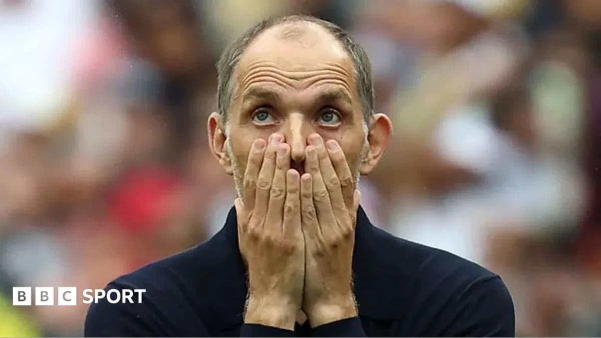 Coach covering face with hands during match